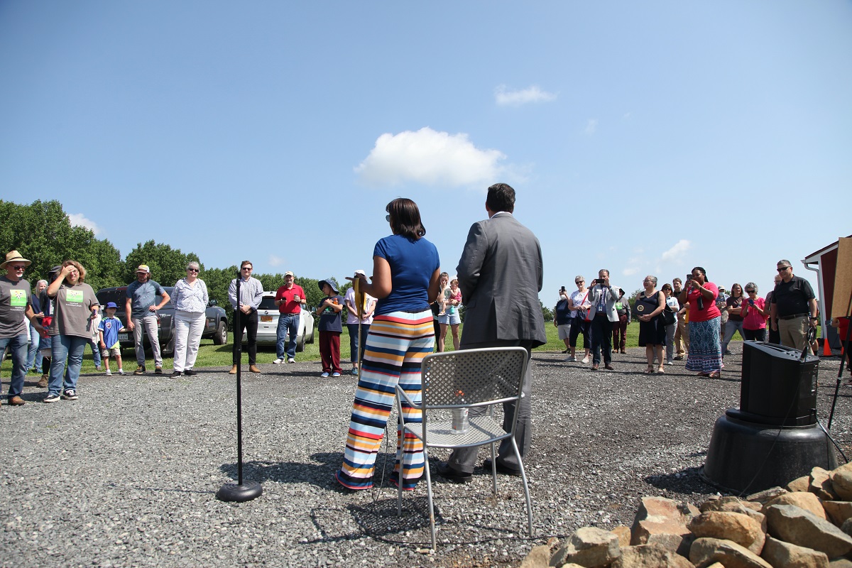 Speakers standing in front of a semi-circle of people