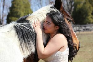 girl embracing a horse