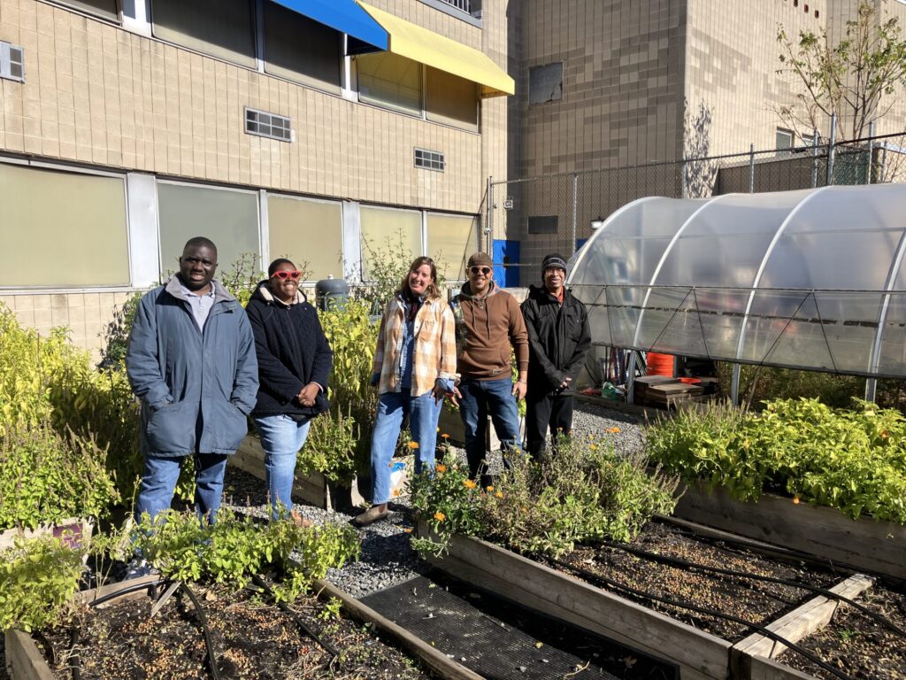 Urban Farmers in front of garden beds in NYC